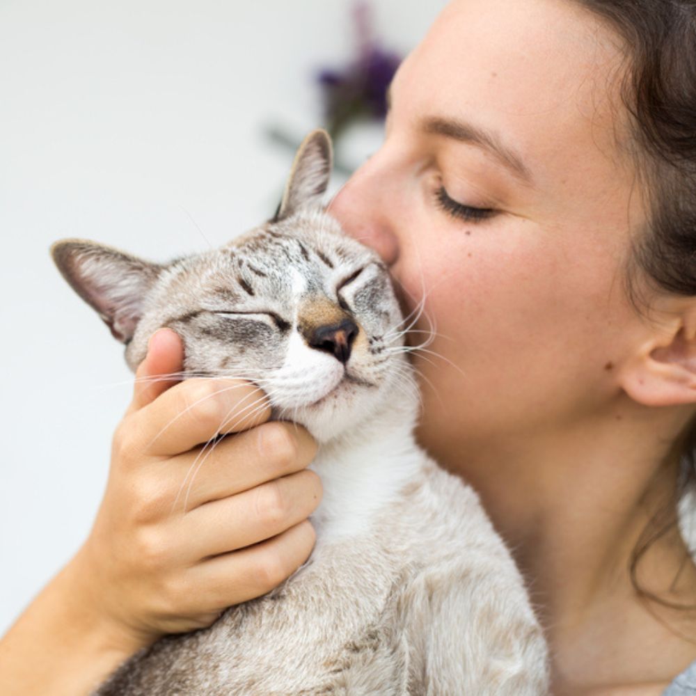 woman kissing her cat